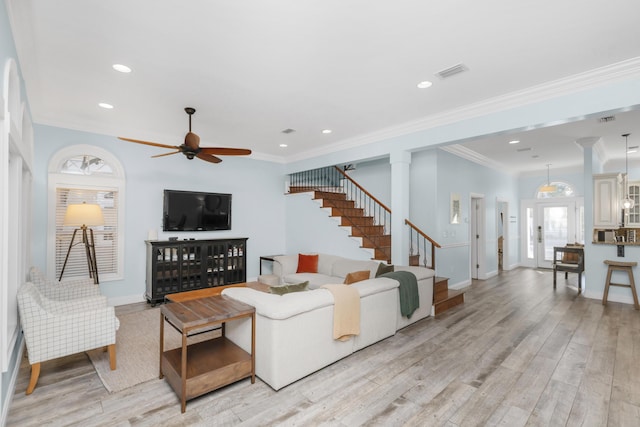 living room featuring light wood-style floors, a ceiling fan, healthy amount of natural light, baseboards, and recessed lighting