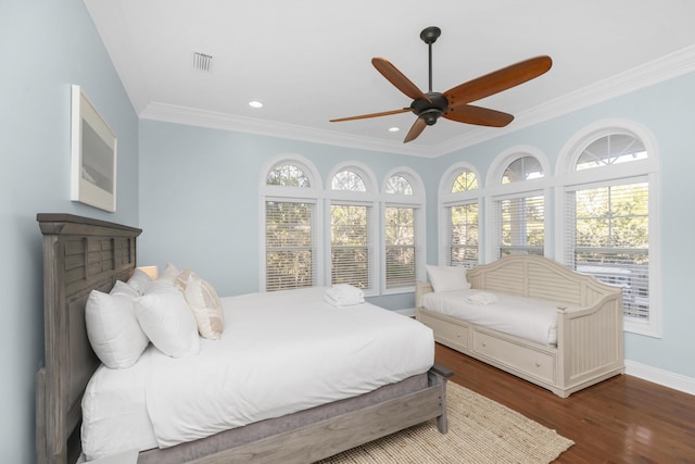 bedroom with wood finished floors, ornamental molding, multiple windows, recessed lighting, and baseboards