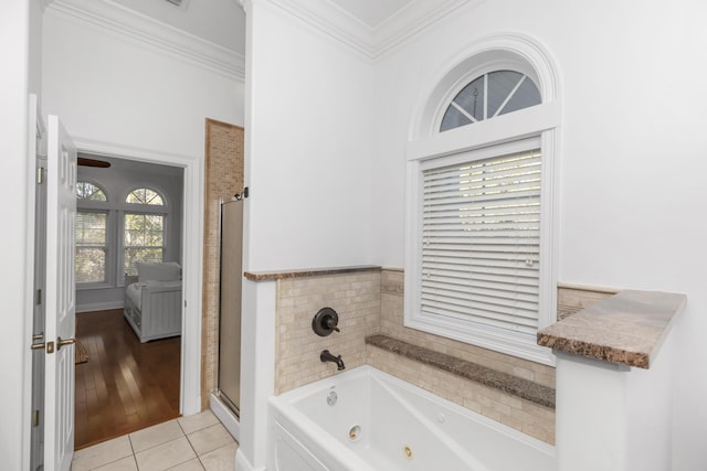 bathroom featuring ornamental molding, a stall shower, a tub with jets, and tile patterned flooring