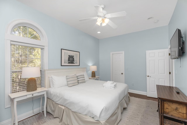 bedroom with wood finished floors, baseboards, and ceiling fan