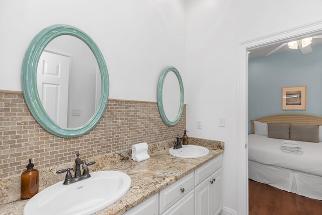 bathroom featuring backsplash and double vanity