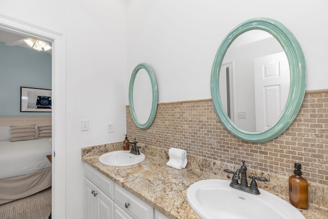 full bathroom featuring double vanity and backsplash