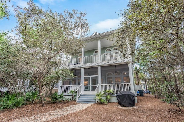 view of front of property featuring a balcony and a sunroom