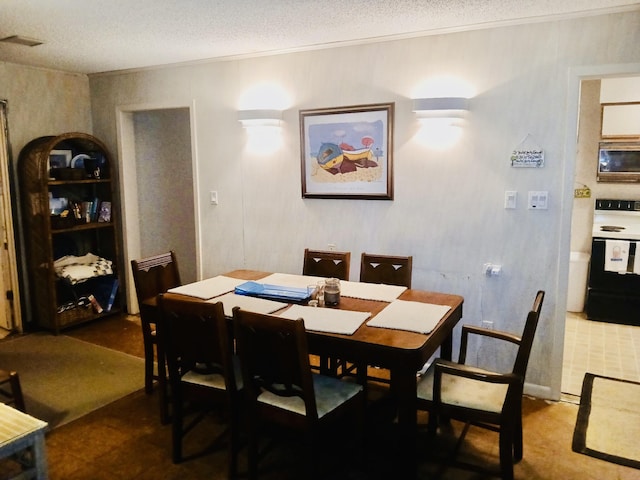 dining space with a textured ceiling