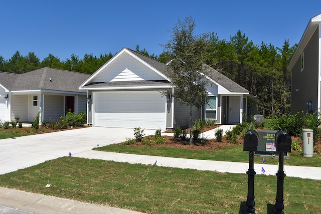 575 Earl Godwin Rd, Freeport, FL 32439 - ranch-style home with an attached garage, driveway, a front lawn, and roof with shingles