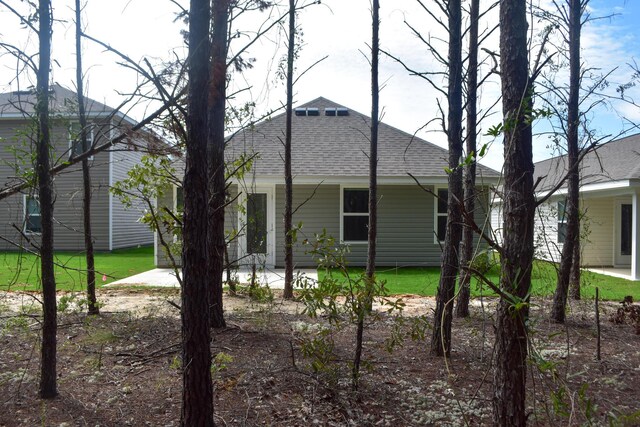 575 Earl Godwin Rd, Freeport, FL 32439 - view of side of property featuring roof with shingles and a patio