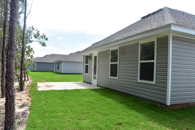 575 Earl Godwin Rd, Freeport, FL 32439 - rear view of property featuring a patio, a lawn, and a shingled roof