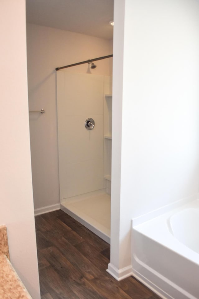 575 Earl Godwin Rd, Freeport, FL 32439 - full bathroom featuring wood finished floors, a shower, a garden tub, and baseboards