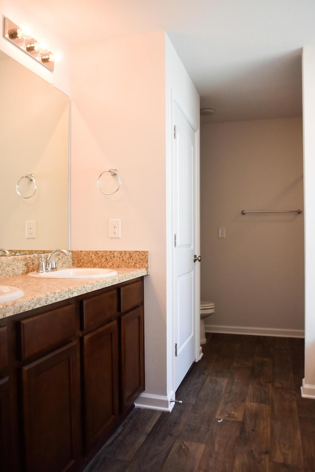 575 Earl Godwin Rd, Freeport, FL 32439 - full bath featuring wood finished floors, double vanity, toilet, and baseboards