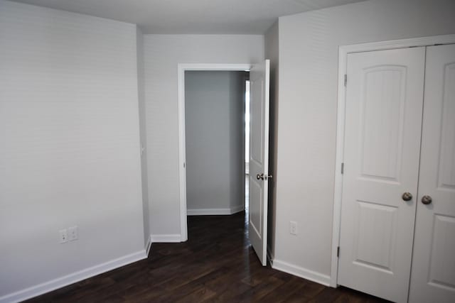 575 Earl Godwin Rd, Freeport, FL 32439 - unfurnished bedroom with dark wood finished floors, baseboards, and a closet