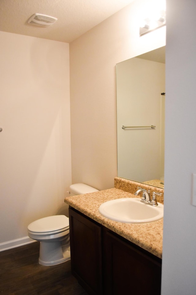 575 Earl Godwin Rd, Freeport, FL 32439 - half bath with wood finished floors, toilet, vanity, and baseboards