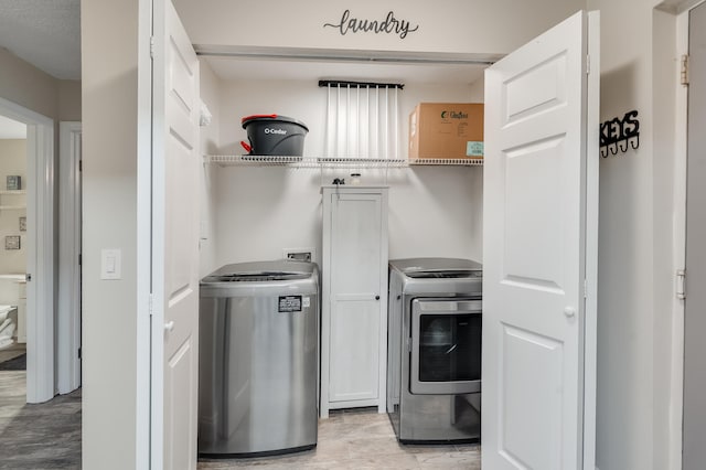 4274 Calinda Ln Unit 215, Niceville, FL 32578 - laundry area featuring cabinet space and separate washer and dryer