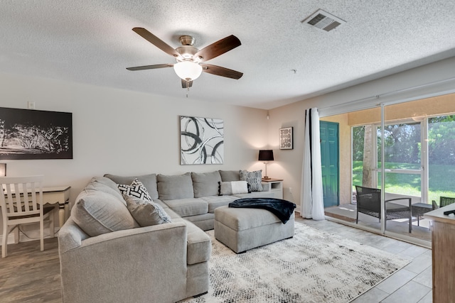 4274 Calinda Ln Unit 215, Niceville, FL 32578 - living room featuring a ceiling fan and a textured ceiling