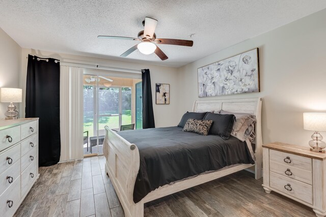 4274 Calinda Ln Unit 215, Niceville, FL 32578 - bedroom with access to exterior, a textured ceiling, light wood-type flooring, and ceiling fan