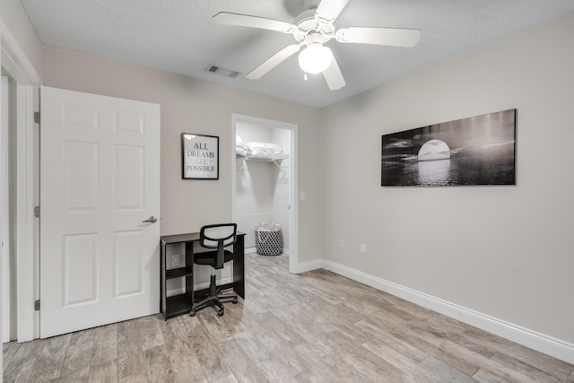 4274 Calinda Ln Unit 215, Niceville, FL 32578 - office area featuring light wood-style floors, a ceiling fan, a textured ceiling, and baseboards