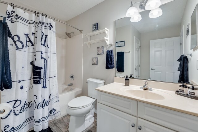 4274 Calinda Ln Unit 215, Niceville, FL 32578 - full bath with wood finished floors, toilet, shower / bath combination with curtain, and vanity