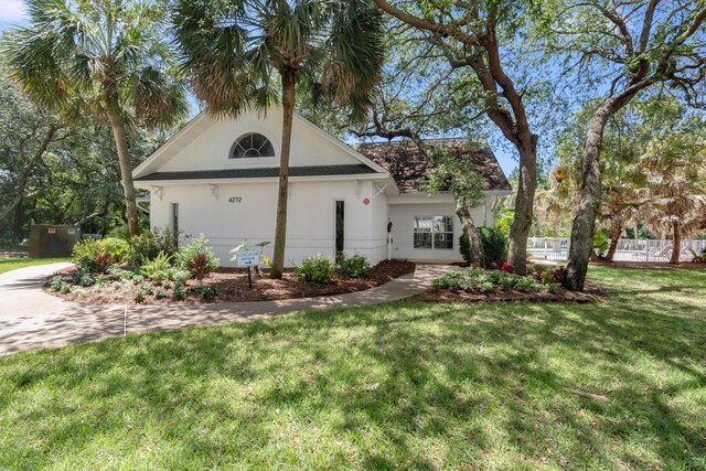 4274 Calinda Ln Unit 215, Niceville, FL 32578 - view of front of home featuring stucco siding and a front lawn