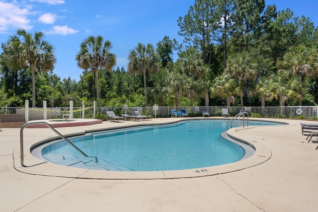 4274 Calinda Ln Unit 215, Niceville, FL 32578 - community pool featuring fence, a patio, and view of scattered trees