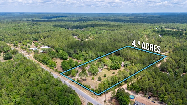 aerial view of property's location with a forest and property boundaries highlighted