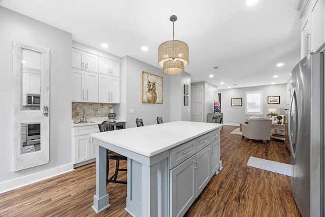 1650 Caswell Rd, Defuniak Springs, FL 32433 - kitchen with stainless steel appliances, dark wood finished floors, open floor plan, recessed lighting, and white cabinetry