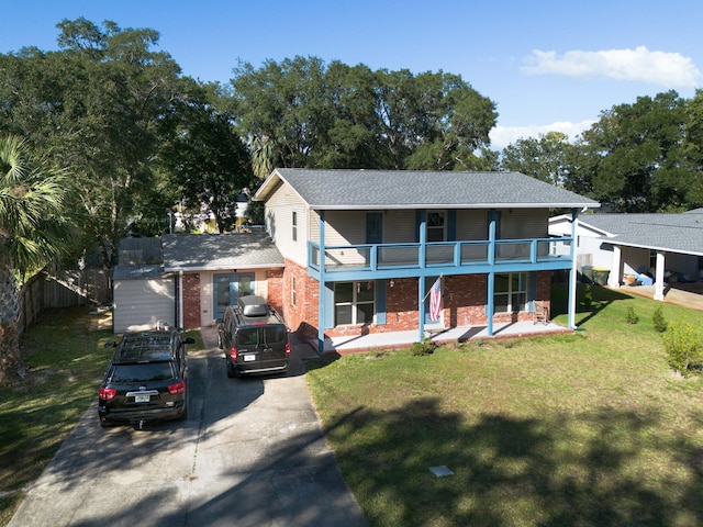 327 NE Yacht Club Dr, Fort Walton Beach, FL 32548 - view of front of house with brick siding, asphalt driveway, a balcony, a porch, and a shingled roof