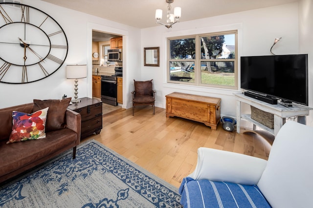 327 NE Yacht Club Dr, Fort Walton Beach, FL 32548 - living area with light wood-style floors and a chandelier