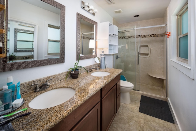 327 NE Yacht Club Dr, Fort Walton Beach, FL 32548 - bathroom featuring toilet, a shower stall, double vanity, and tile patterned floors