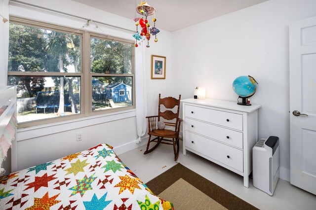 327 NE Yacht Club Dr, Fort Walton Beach, FL 32548 - bedroom featuring multiple windows and concrete floors