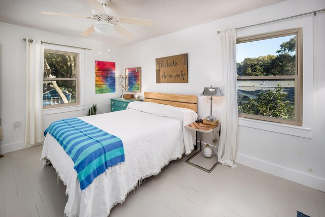 327 NE Yacht Club Dr, Fort Walton Beach, FL 32548 - bedroom featuring multiple windows, ceiling fan, and baseboards