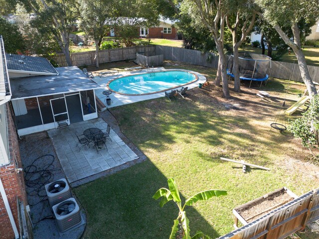 327 NE Yacht Club Dr, Fort Walton Beach, FL 32548 - view of swimming pool with a trampoline, a patio area, and a sunroom