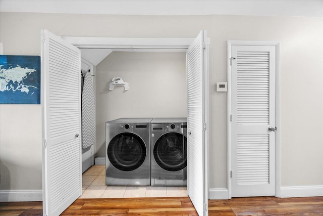 2000 Scenic Gulf Dr Unit 3, Miramar Beach, FL 32550 - washroom featuring baseboards, washing machine and dryer, and wood finished floors