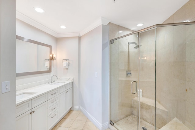 bathroom featuring a stall shower, ornamental molding, tile patterned floors, double vanity, and baseboards