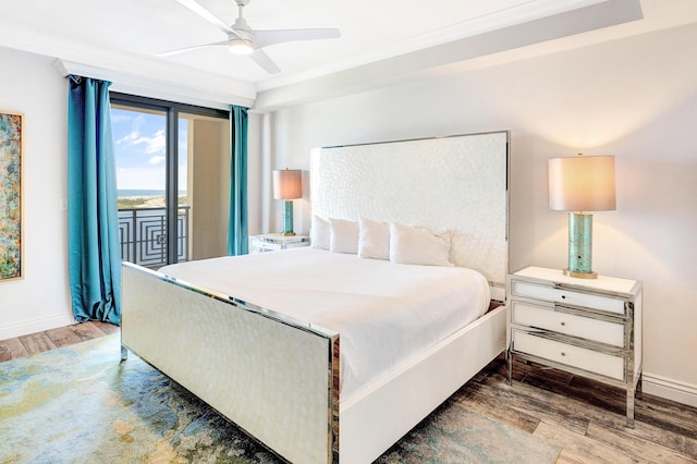 bedroom featuring wood finished floors, access to exterior, baseboards, and a ceiling fan