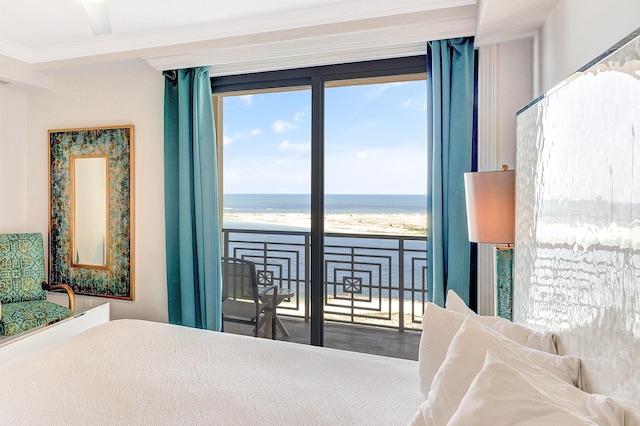 bedroom featuring view of water and beach and access to exterior