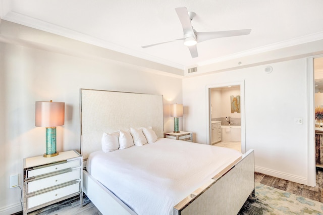 bedroom with ornamental molding, light wood finished floors, ceiling fan, and ensuite bathroom