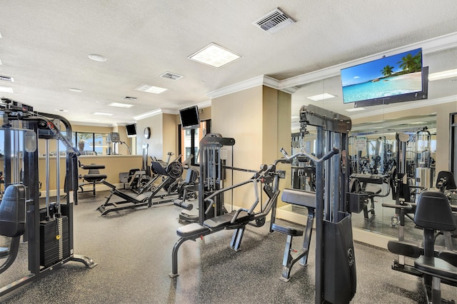 gym with crown molding, a textured ceiling, and baseboards