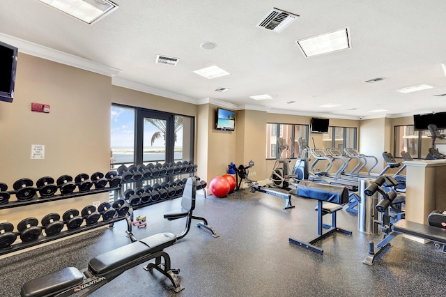 workout area featuring crown molding