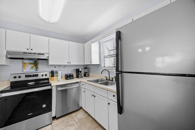 25 Misty Cv Unit 118, Miramar Beach, FL 32550 - kitchen featuring stainless steel appliances, under cabinet range hood, a sink, light countertops, and white cabinets