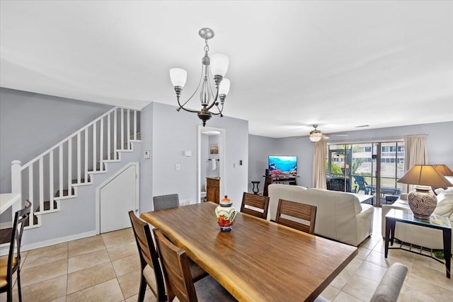 25 Misty Cv Unit 118, Miramar Beach, FL 32550 - dining space featuring light tile patterned floors, stairway, a chandelier, and ceiling fan