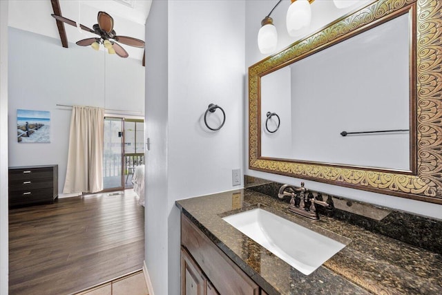 25 Misty Cv Unit 118, Miramar Beach, FL 32550 - bathroom with vanity, a towering ceiling, a ceiling fan, wood finished floors, and baseboards