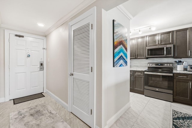 520 N Richard Jackson Blvd Unit 1510, Panama City Beach, FL 32407 - kitchen featuring appliances with stainless steel finishes, baseboards, dark brown cabinetry, crown molding, and light marble finish flooring