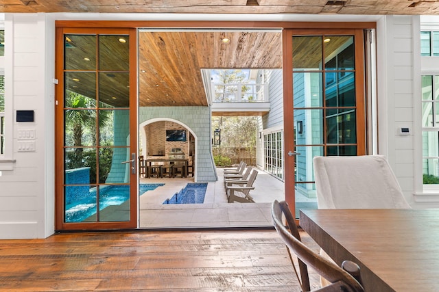doorway featuring hardwood / wood-style floors and expansive windows