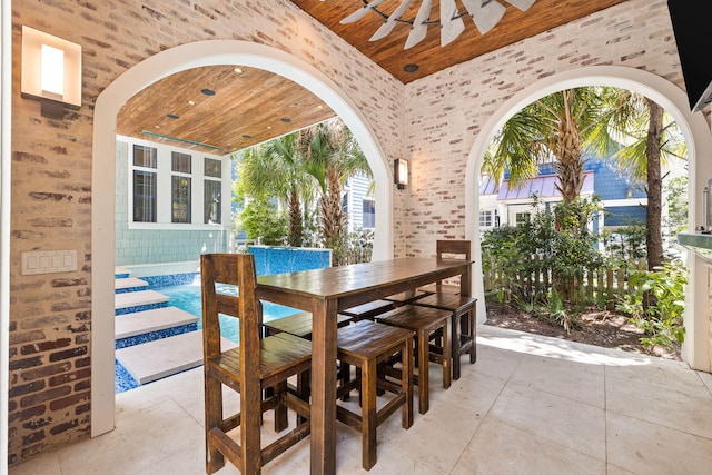 tiled dining room featuring wooden ceiling, high vaulted ceiling, and arched walkways