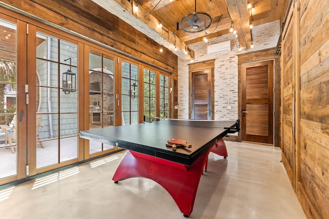 game room featuring wooden ceiling, finished concrete flooring, wooden walls, a wall mounted air conditioner, and beam ceiling