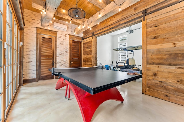 playroom with finished concrete flooring, wood ceiling, a wall mounted AC, and beam ceiling