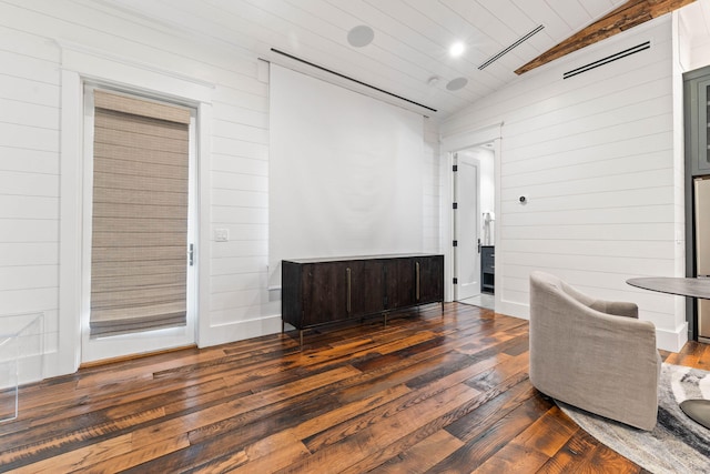 living area with dark wood finished floors, wooden walls, wood ceiling, and lofted ceiling