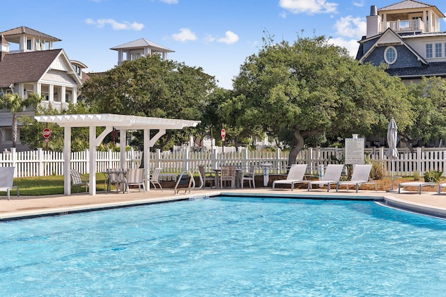 community pool featuring fence and a patio