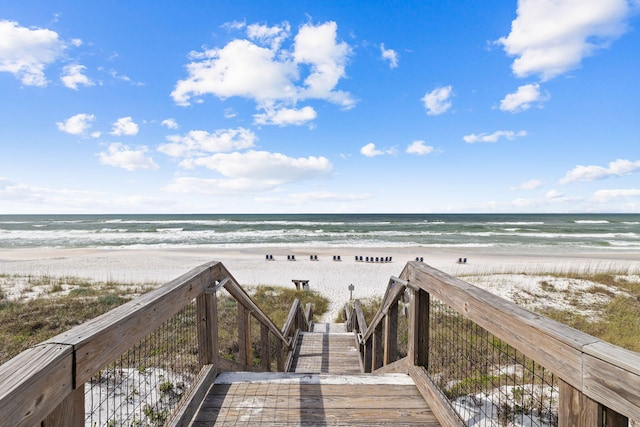 view of home's community with view of water and beach
