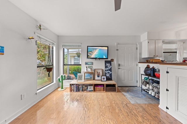 entrance foyer featuring light wood-type flooring, baseboards, and a ceiling fan