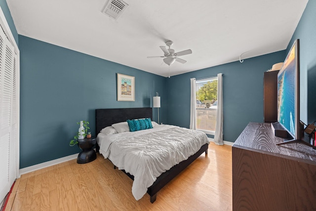 bedroom featuring wood finished floors, baseboards, and a ceiling fan